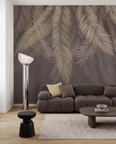Hanging beige palm fronds on a dark mocha background wall mural behind a brown sofa