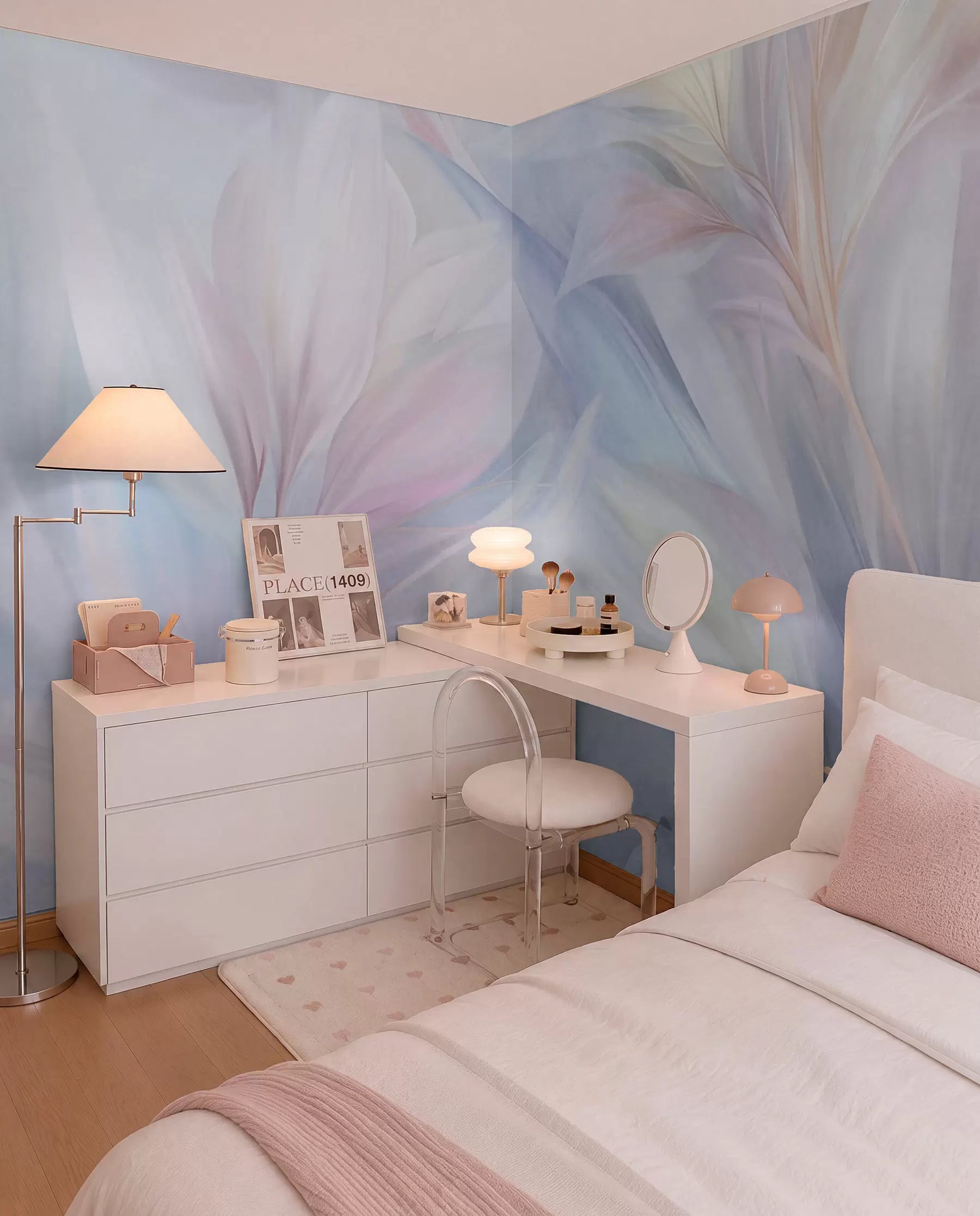 Pastel pink, blue and yellow abstract leaves and feathers wall mural in a bedroom with a white vanity desk