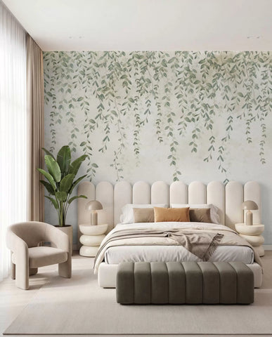 Hanging green vines and foliage wall mural on soft grey behind a bed with a bench