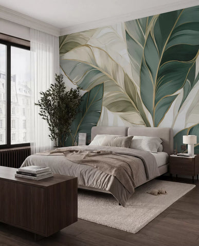 Green tropical leaf mural behind a bed with grey bedding in a modern bedroom