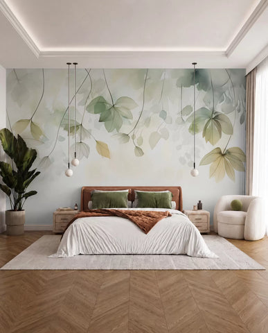 Sage green watercolor leaf mural behind a bed with white linen and a rust throw