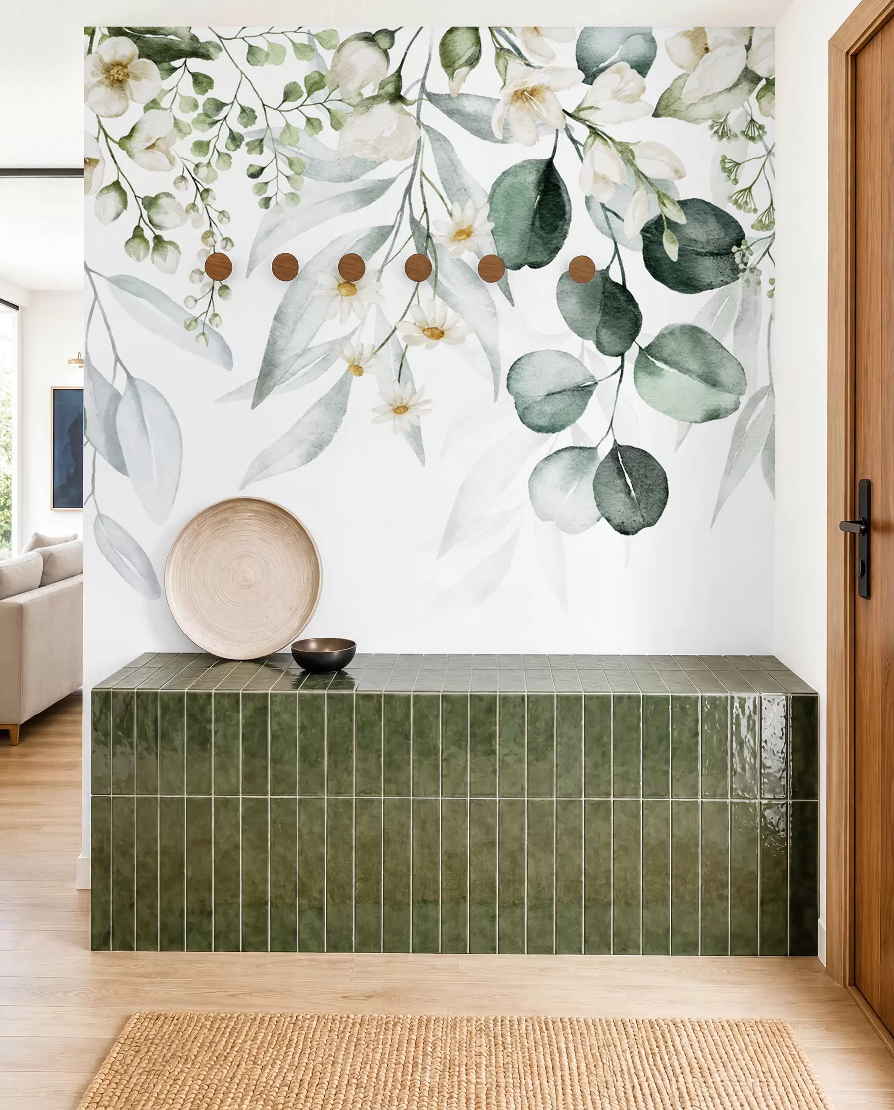 Watercolor green leaves and white flowers wall mural above a green tiled bathtub