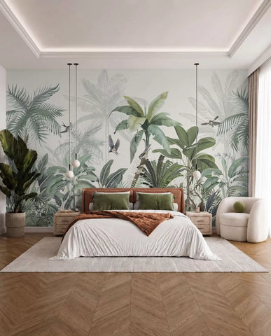 Tropical jungle wall mural with palm trees in soft green behind a bed with a rust throw and cream armchair