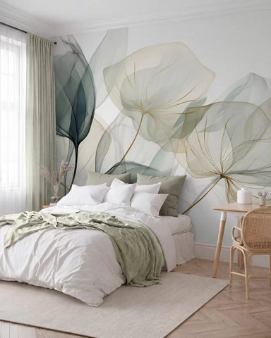 Sheer layered leaf mural in green and cream behind a bed with white linen