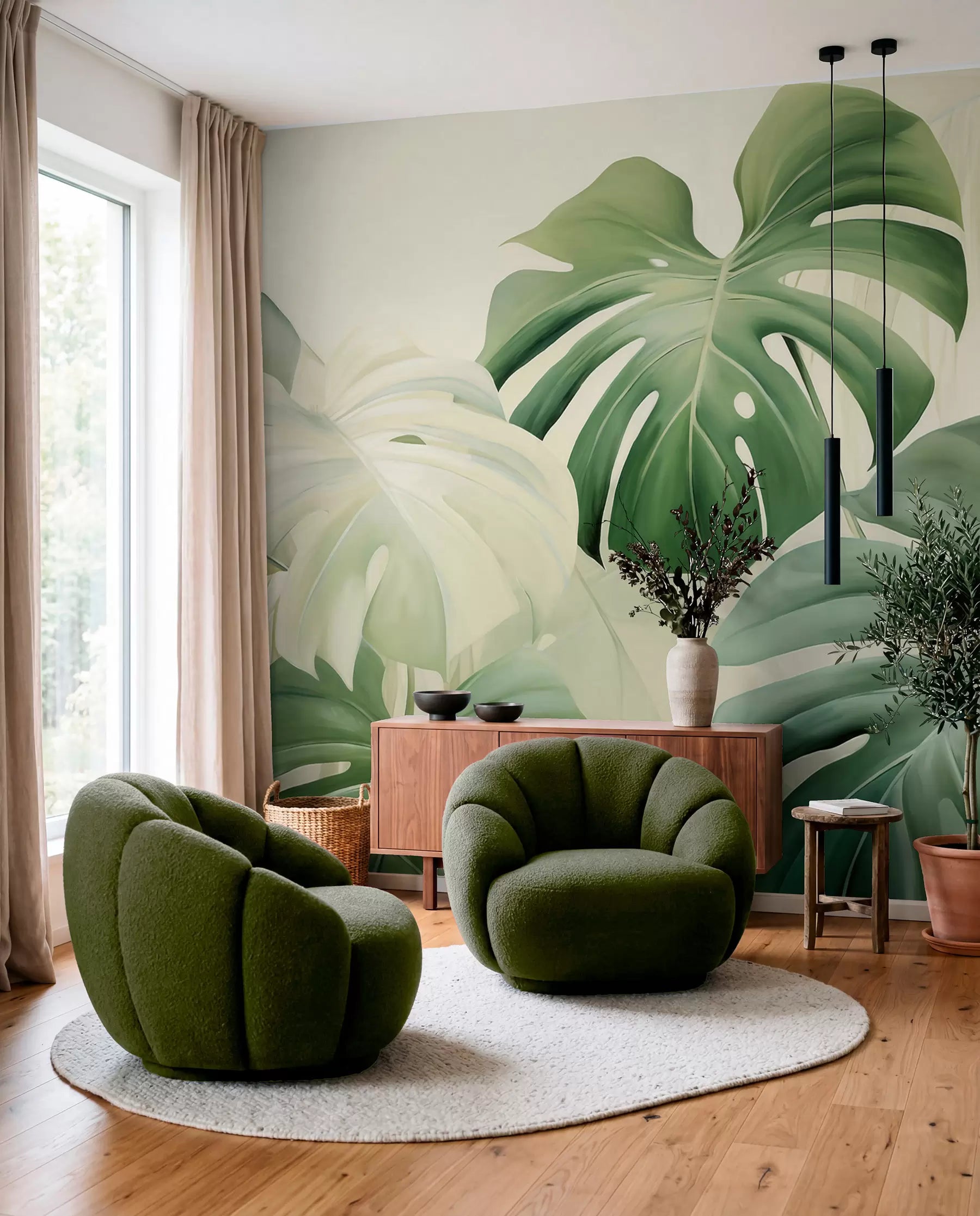 Large green monstera and palm leaves wall mural behind two green velvet armchairs
