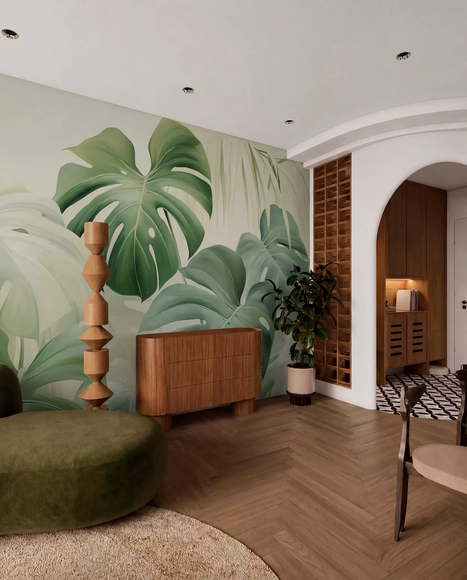 Green monstera leaf mural in a room with an arched doorway and wooden sideboard
