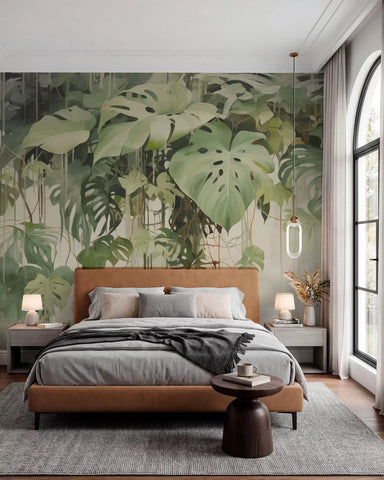 Lush green tropical leaves and palms wall mural behind a bed with rust bedding