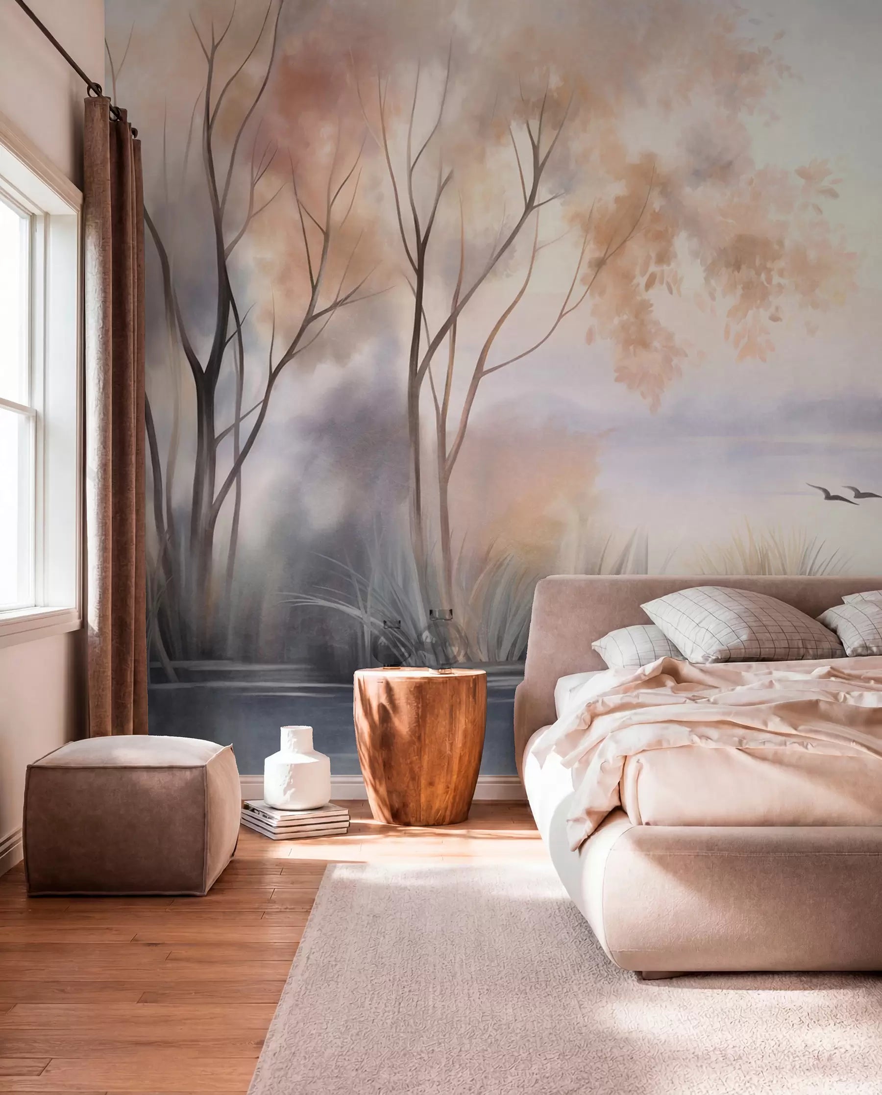 Textured watercolor misty lake wall mural with trees, reeds and flying birds behind a blush bed