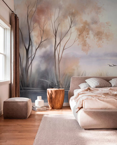 Textured watercolor misty lake wall mural with trees, reeds and flying birds behind a blush bed