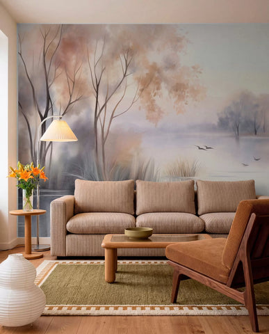 Misty lake landscape mural in peach and lilac tones in a living room with a beige sofa