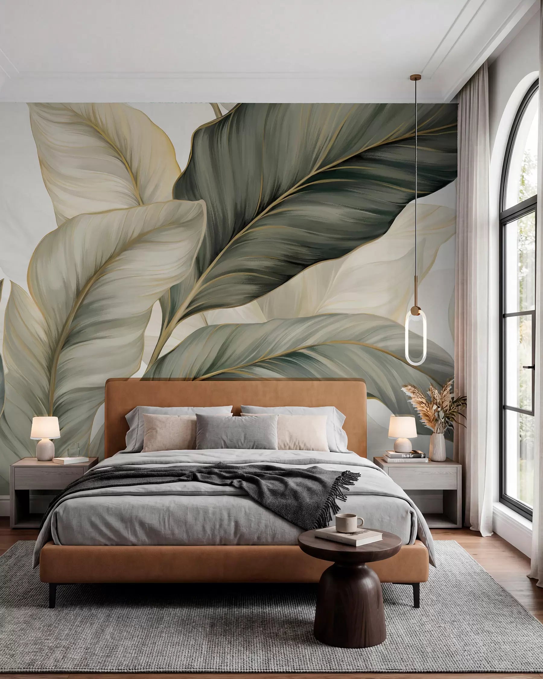 Large sage, olive and cream ribbon-like leaves wall mural behind a tan leather bed
