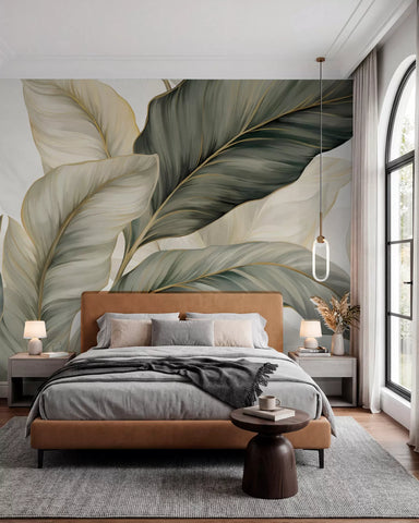Large sage, olive and cream ribbon-like leaves wall mural behind a tan leather bed