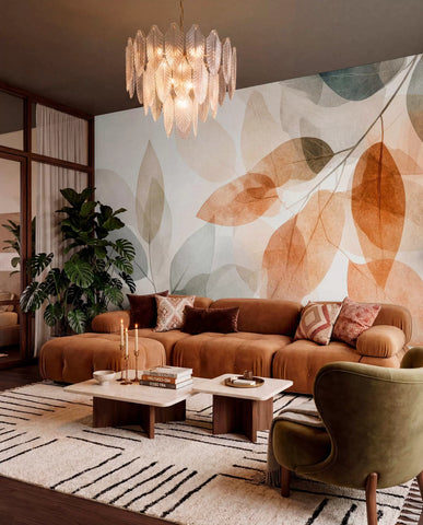 Amber and grey leaf mural in a living room with a rust sofa and crystal chandelier