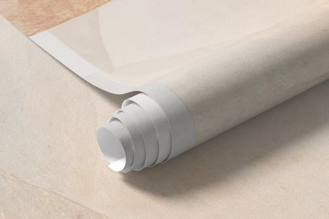 Rolled amber and grey leaves mural wallpaper on a cream background