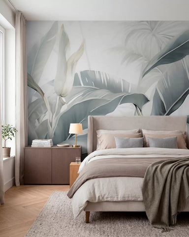 Azure banana leaves wall mural in teal and sage behind a bed with grey and taupe bedding