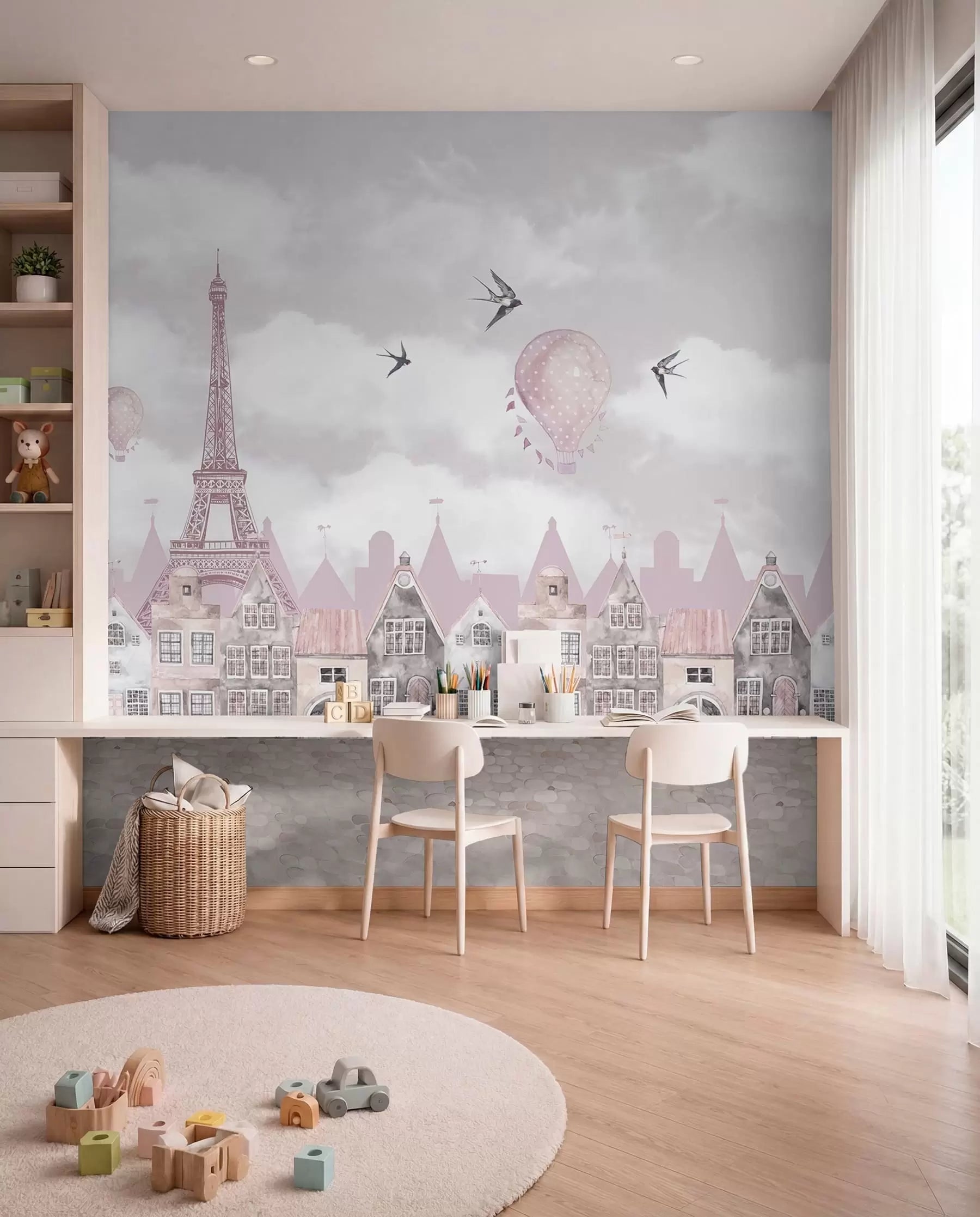 Pink Paris skyline mural above a kids' study desk with two chairs